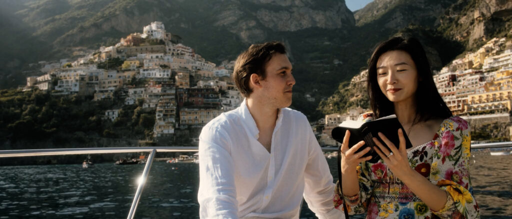 alec e yin on a boat near positano