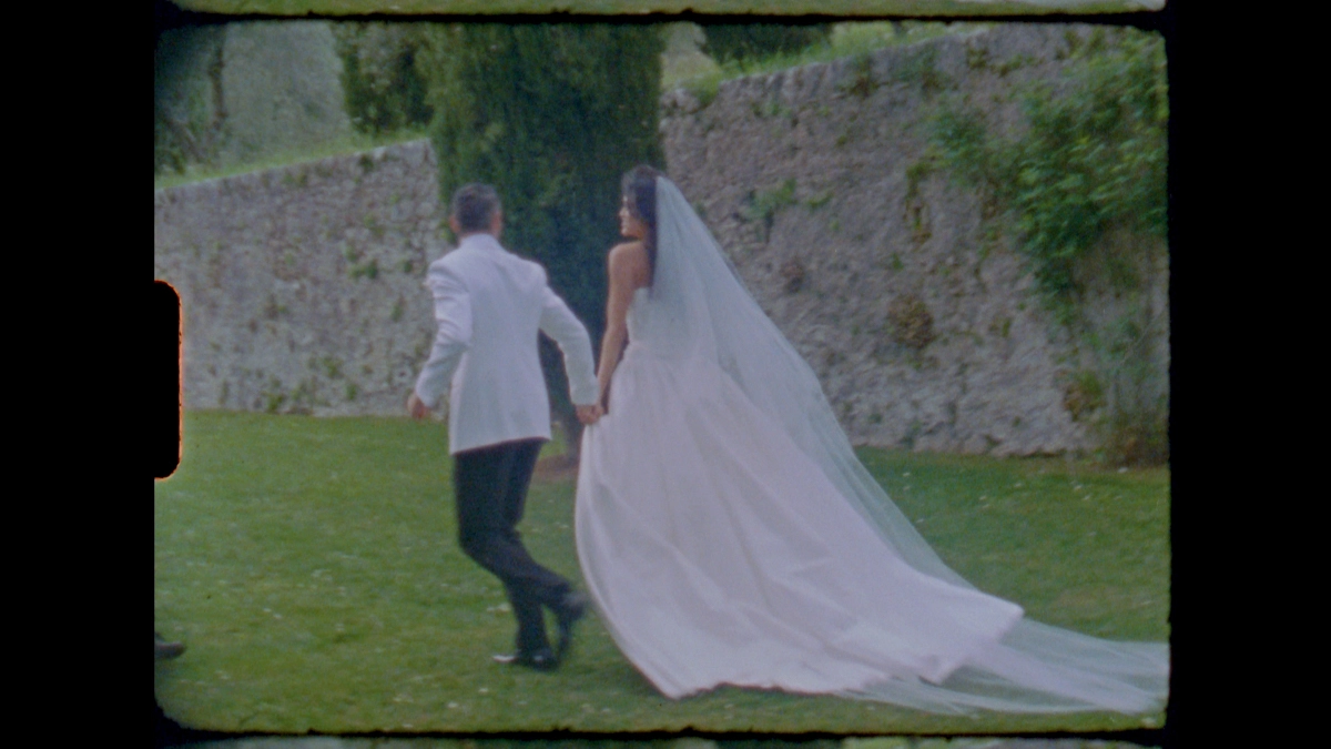 The newlyweds running on the grass