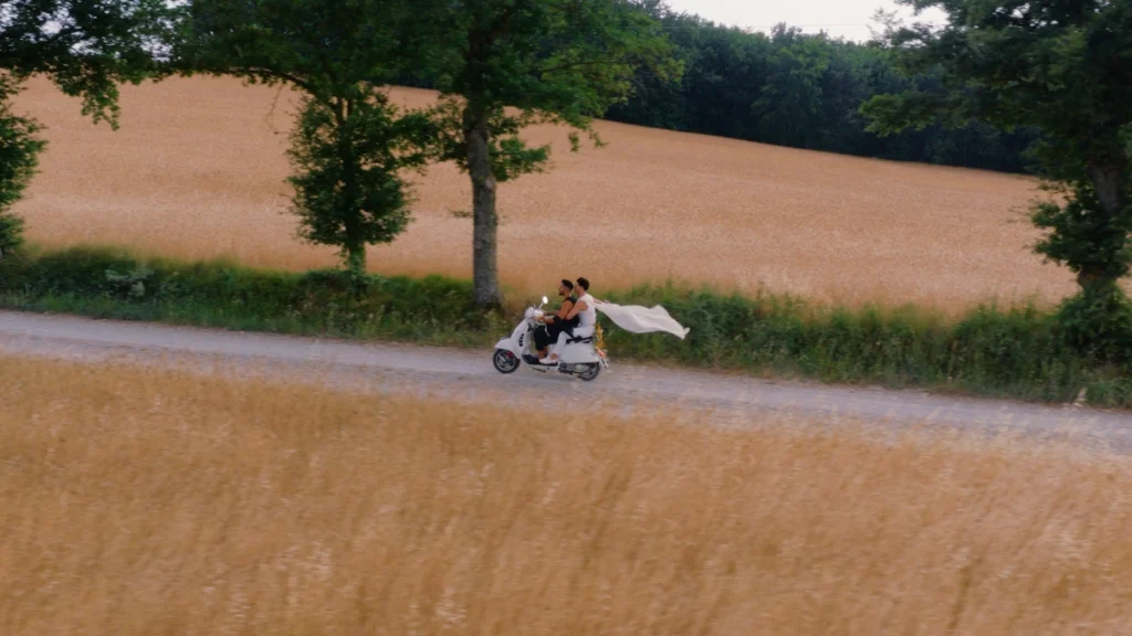 The spouses riding a motorbike in tuscany's countryside