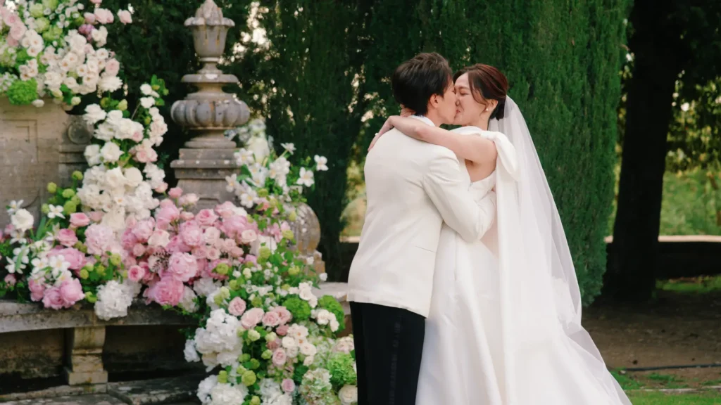 The newlyweds kissing during the ceremony in La Foce
