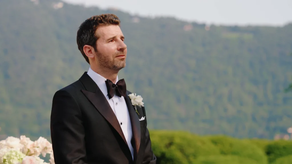 Emotional groom watching the bride walk down the aisle